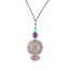 Collier art déco Ciewenn long composé d’un cordon noir, d’un joli filigrane argenté, garni d’un plastron coloré, de perles bleues, violettes et argentés.