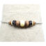 Bracelet ethnique Ciewenn composé d'une chaîne bille en inox, orné d'un mélange harmonieux de perles en pierre écru et en bois beige marron et noir