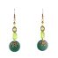 Boucles d’oreilles hippies chics Ciewenn ethniques composées de perles d'un mélange harmonieux de perles verrts et bronze, du bois, du verre et du métal.
